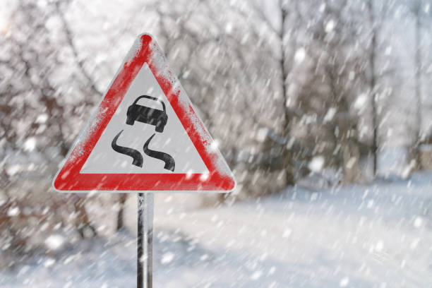 Warning road sign before ice break. Snowy road ad winter.