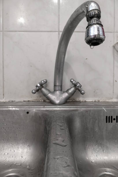 istock Kitchen faucet with dripping water 1202538772