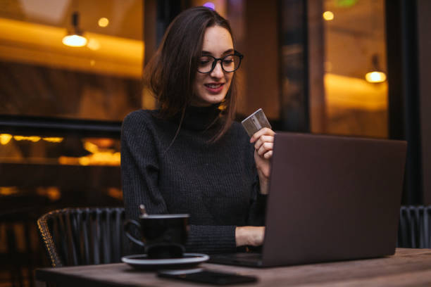 istock Woman shopping online in cafe 1202539057