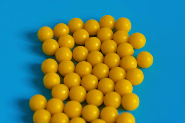 istock Yellow vitamins on a blue background. Vitamin complex against the virus. Multivitamins to enhance health and immunity. Medical concept 1202539902