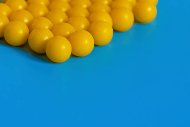 istock Yellow vitamins on a blue background. Vitamin complex against the virus. Multivitamins to enhance health and immunity. Medical concept 1202539918