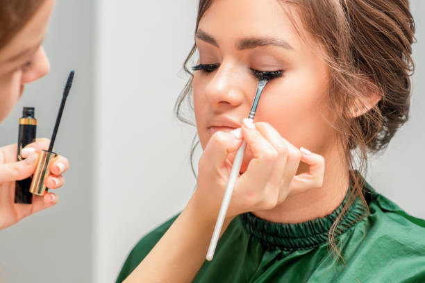 istock Makeup artist applies eye shadow powder. 1202540238