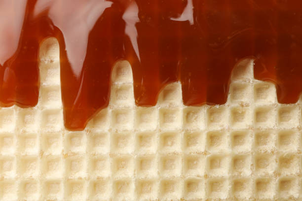 Wafer with caramel topping texture background, close up