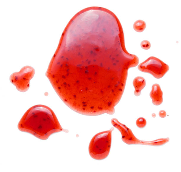 istock red raspberries jam splash isolated on white background 1202542238