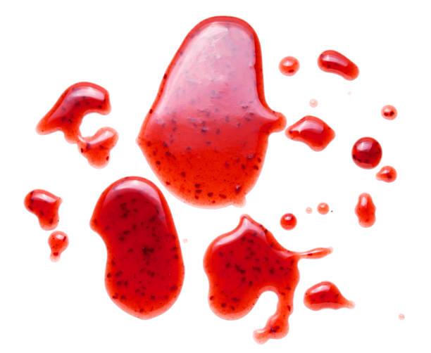 istock red raspberries jam splash isolated on white background 1202542250