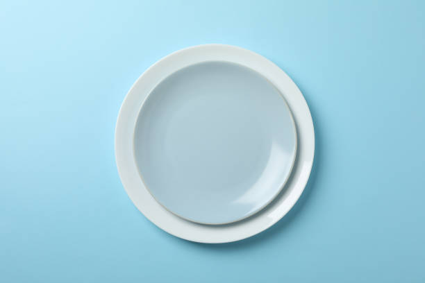 istock Plates on blue background, top view and space for text 1202543685