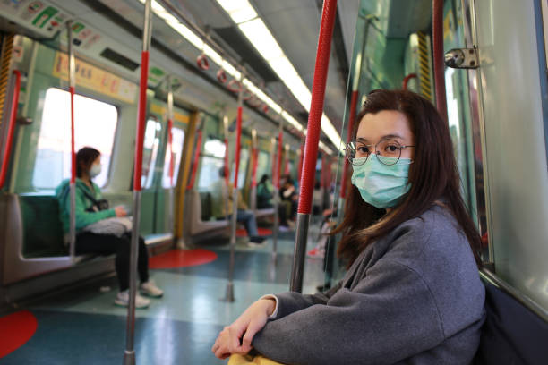 masked girl to protect herself from wuhan virus in public area masked girl to protect herself from wuhan virus in public area scuba mask stock pictures, royalty-free photos & images