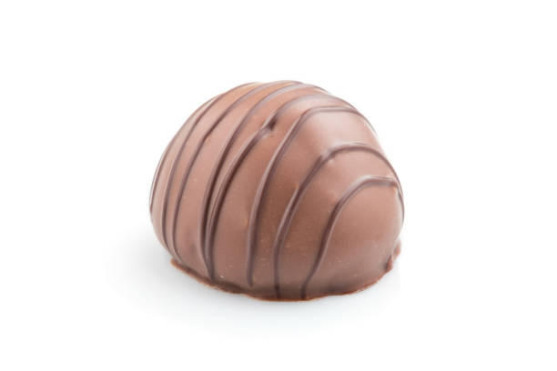 istock Single chocolate candy isolated on white background. side view, close up. 1202544664