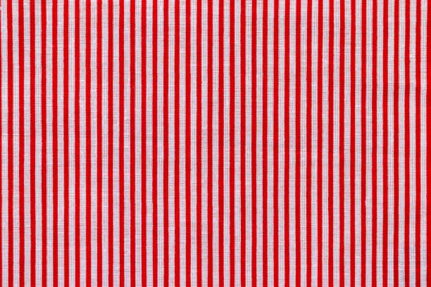 istock Red and white striped fabric texture. Bright colored cotton background 1202545246