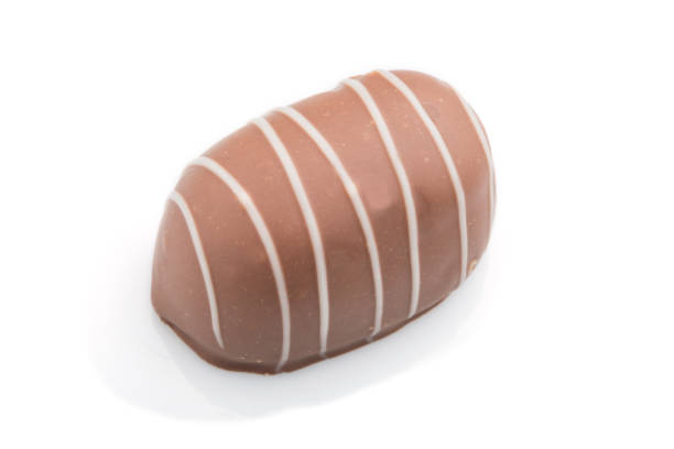 istock Single chocolate candy isolated on white background. side view, close up. 1202545560