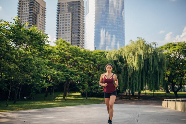 istock Woman jogging in city park 1202546751