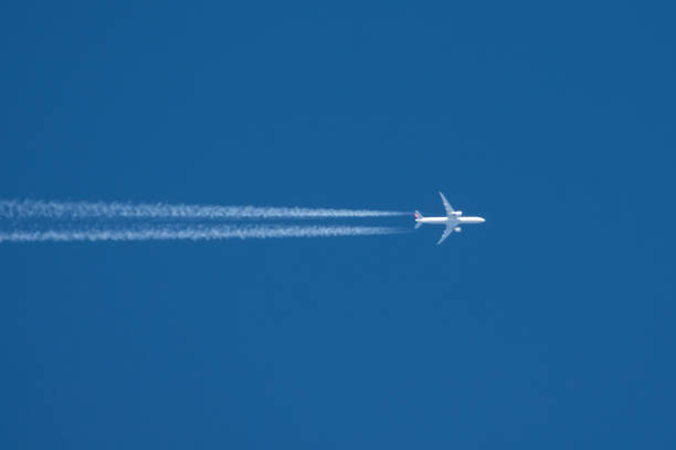 istock Trail from the plane with two enigine the blue sky. 1202546957