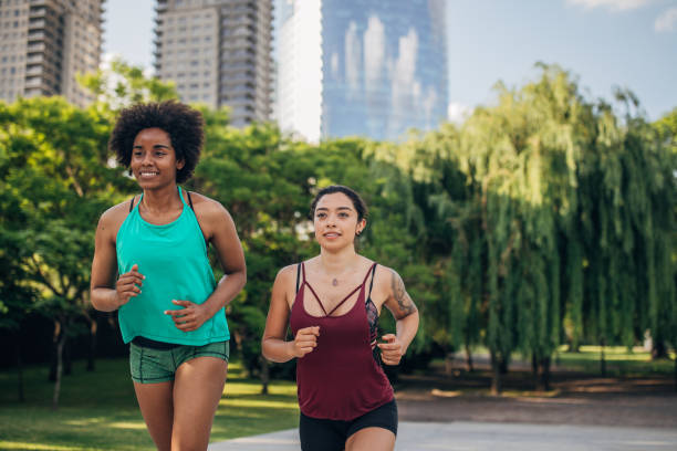 istock Two ladies jogging in city park 1202548787