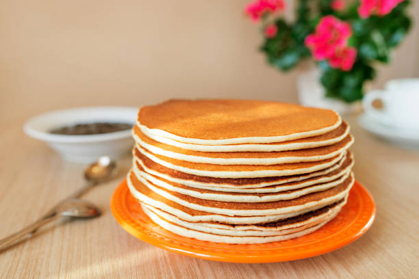 Real food. Pancakes on the table with home flower. Authentic breakfast stock photo