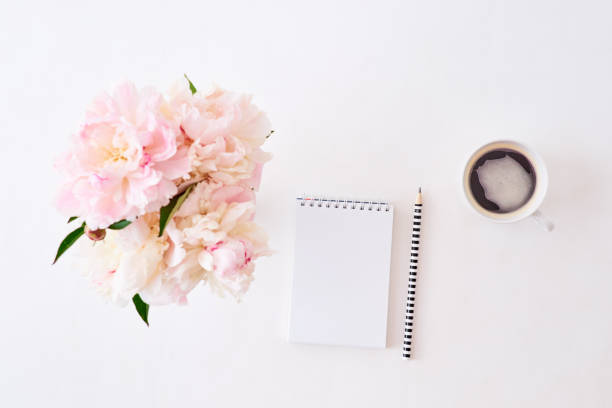 istock Mockup white notebook with pink peonies on a white background 1202550251