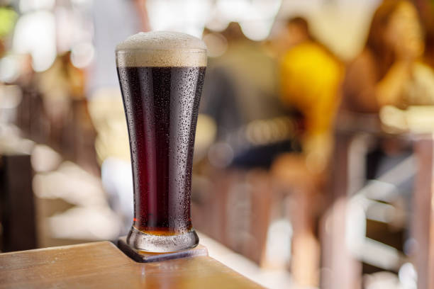 istock Beer glass isolated on a white background. Contains clipping path. Brown beer. 1202550835