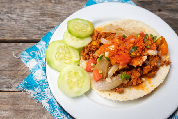 istock Mexican tacos on wooden background 1202550863