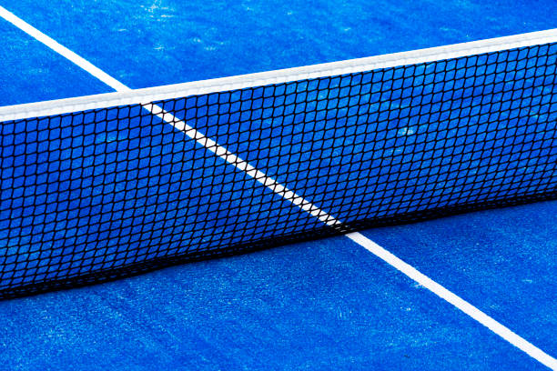 istock Blue paddle tennis court field with net background 1202550937