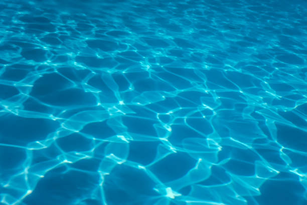 istock Swimming Pool water. Ripple Water. Sun Reflection background. 1202552246