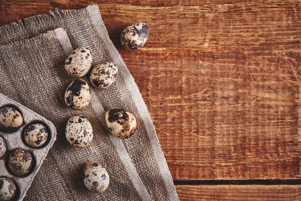 istock Quail eggs on wooden table decorated in a rustic style for Easter close-up with empty copy space for text 1202552270