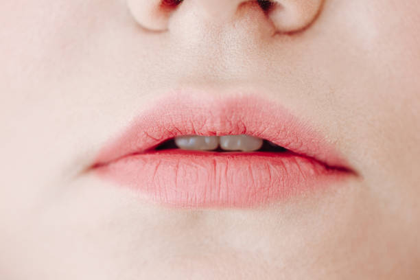 istock Woman Glossy Pink Lips Closeup Front View Photo 1202553477