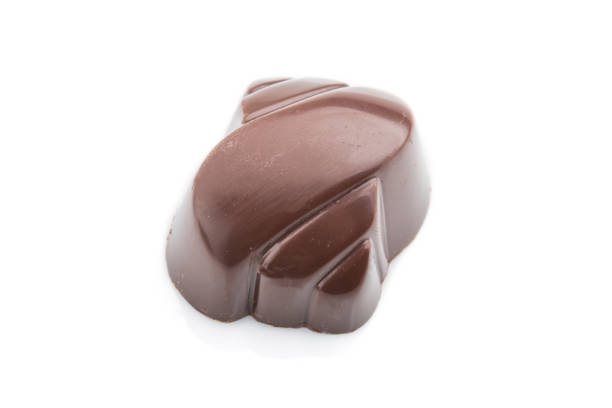 istock Single chocolate candy isolated on white background. side view, close up. 1202554084