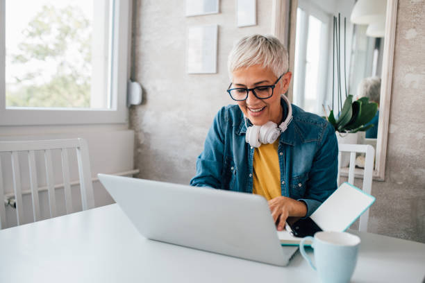 istock Mature woman freelancing from her home office 1202555192