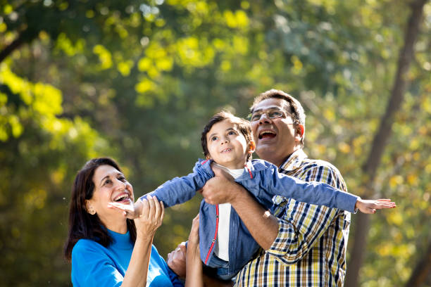 istock Cheerful father lifting daughter and helping her fly 1202556052