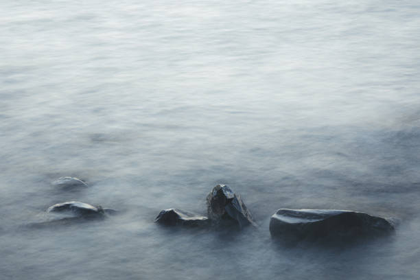 istock Long exposure of waves and rocks at dawn 1202556061