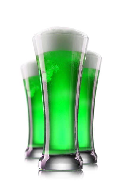 istock Green beer in glasses isolated on a white background. 1202558083