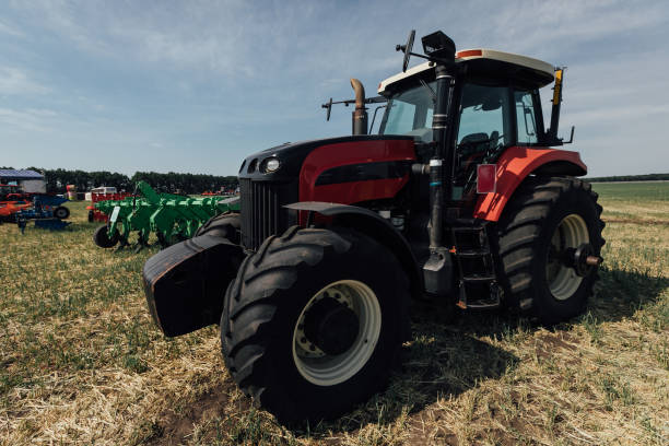 istock red tractor with big wheels in the field 1202561033