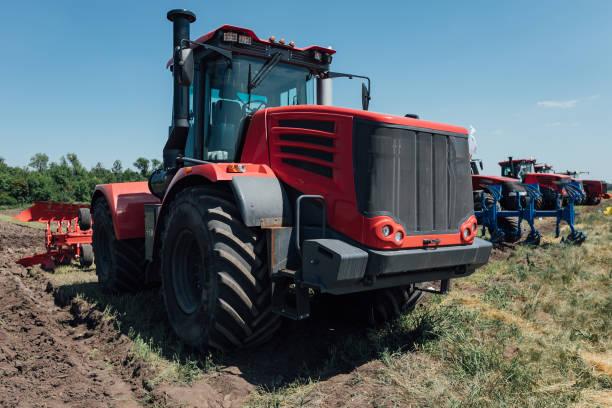 istock red tractor with big wheels in the field 1202561053