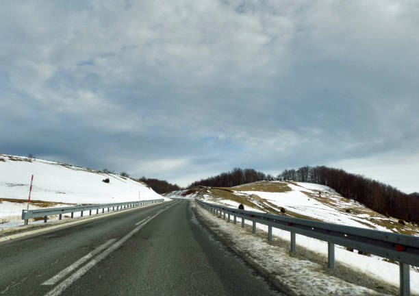 istock Protective road shoulder on winding mountain road 1202561447