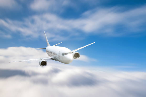 istock Jet passenger plane flying over cloudy sky in day time. 1202562337
