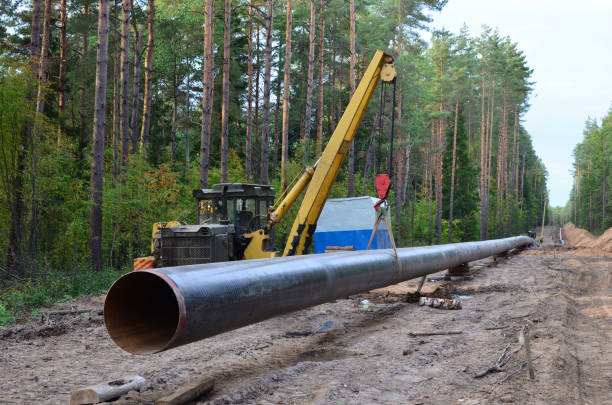 istock Crawler crane with side boom or pipelayer bulldozer. Natural gas pipeline construction work. 1202562890