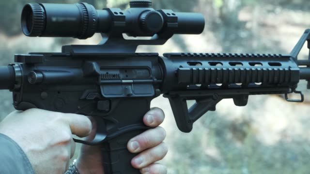 Close up the AR 15 military rifle with a sight.