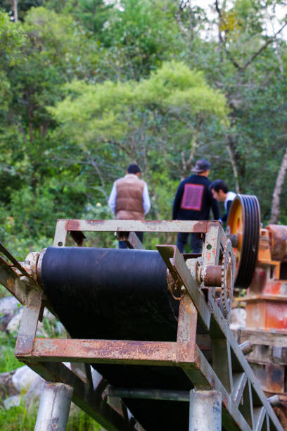istock Metal machine and 3 people in the background 1202565052