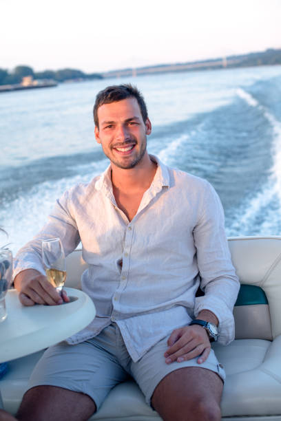 istock Men on yacht, drinking champagne 1202566606