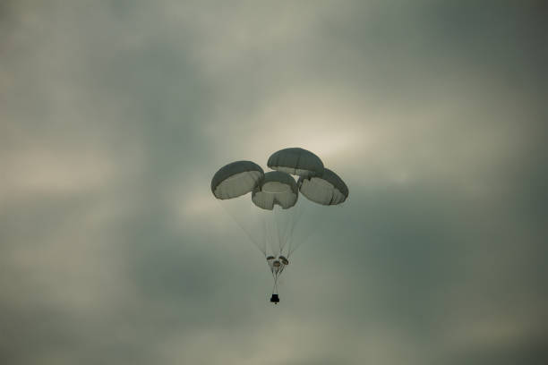 istock Supply box dropped with parashute at military field 1202568817