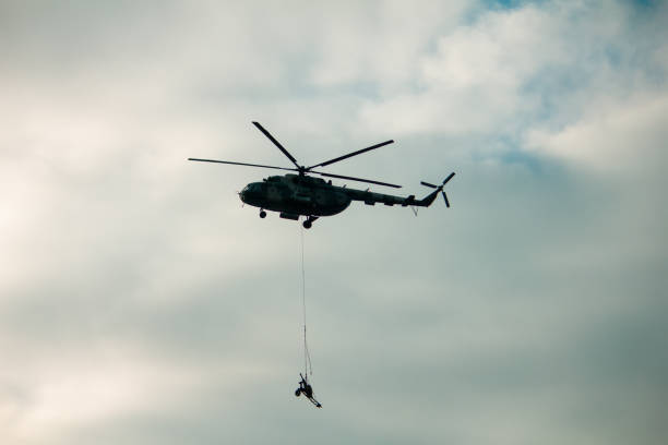 istock military army helicopter transporting an artillery piece. 1202568836