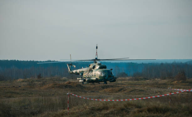 istock Helicopter in flight at sunset above war field 1202568936