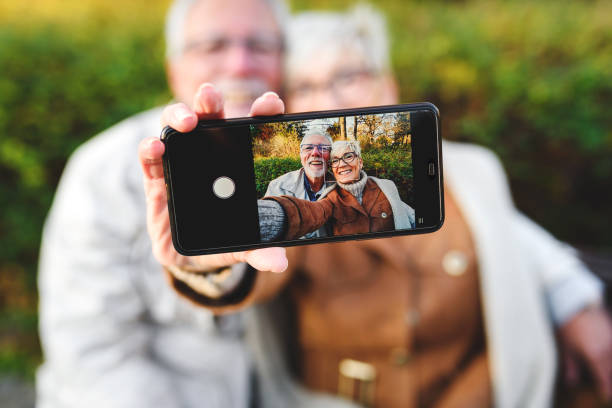 istock Cheerful seniors using modern technology. Taking selfie photos. 1202569747