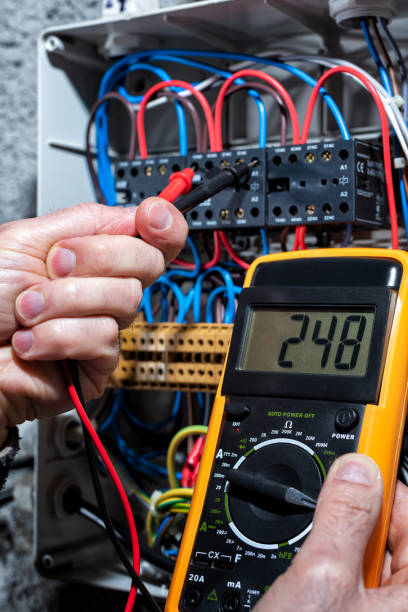 istock Electrician working on a residential electrical panel. Electricity. 1202569828