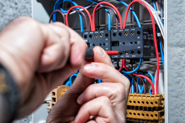 istock Electrician working on a residential electrical panel. Electricity. 1202569847