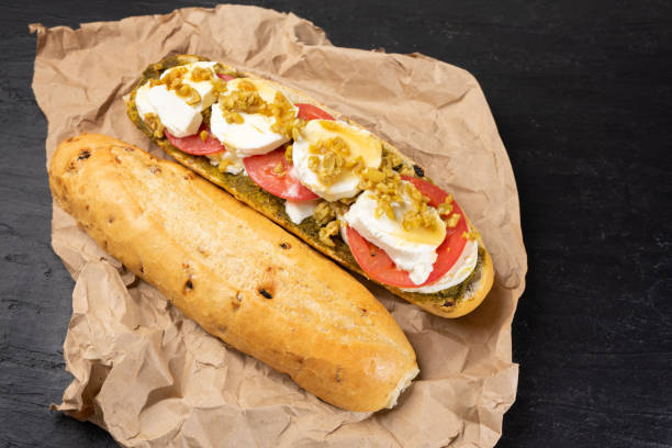istock Goat cheese and honey sub sandwich on dark background 1202572872