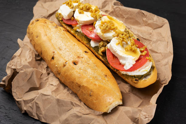 istock Goat cheese and honey sub sandwich on dark background 1202573395