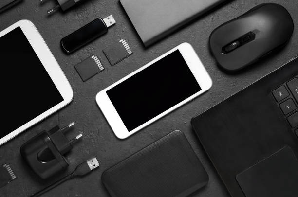 istock Electronic gadgets on a black concrete background. Concept of accessories for successful business. Flat lay. 1202574020