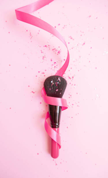 istock Make Up brush with pink glitter wrapped in ribbon 1202576191