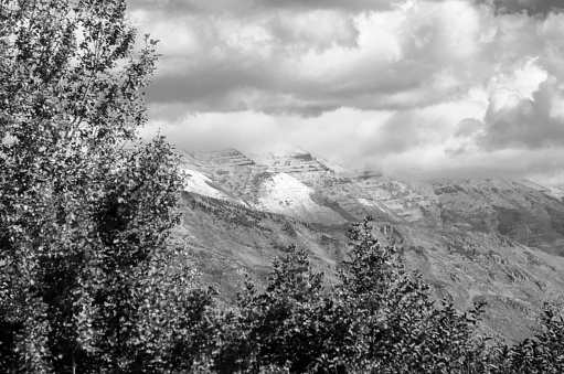 Dramatic Ogden and mountains in Salt Lake City, Utah with snow during the fall