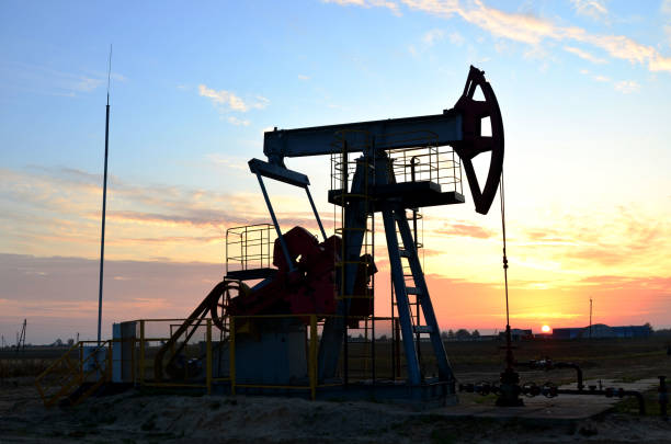 istock Pumpjack (Oil Rig) In The Sunset. Oil drill rig and pump jack 1202577685